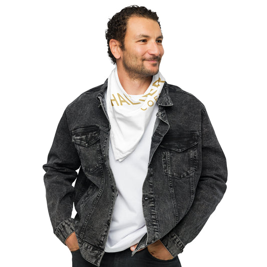 Man wearing black jeans and black jean jacket and a while shirt with a white Halter & Hearth branded white bandana with gold letters and a white background.