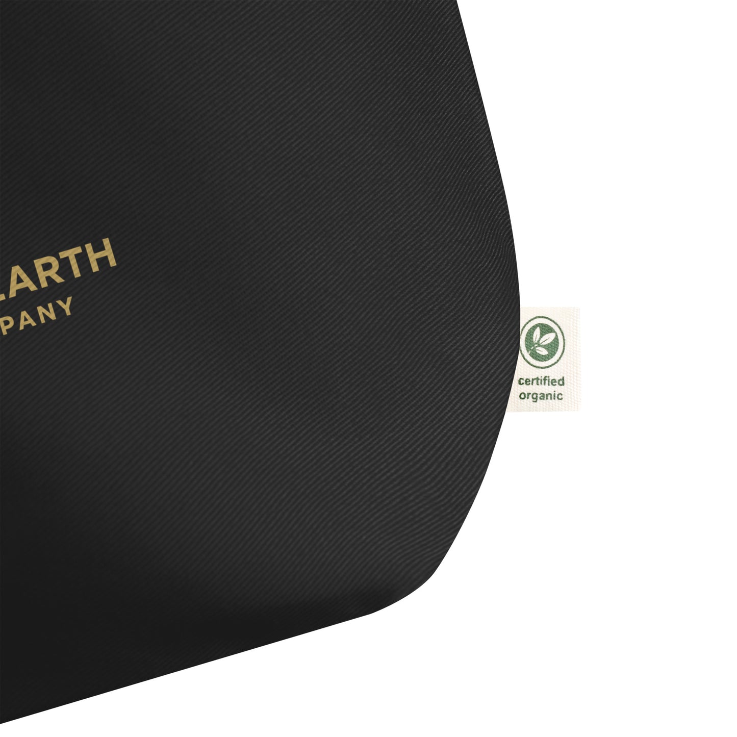 Certified Organic tag on a black Halter & Hearth tote bag on a white background. p